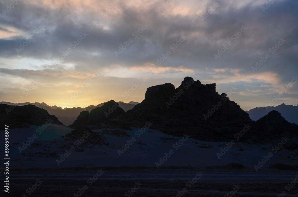 peaks of mountains in the desert against sunset
