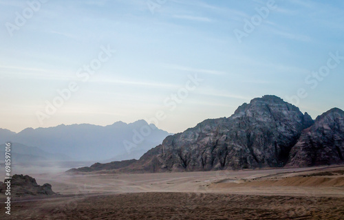 desert with rocky mountains and sky with clouds in the evening in Egypt