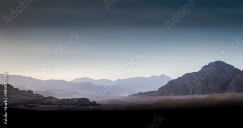 night desert landscape with rocky mountains and sunset sky with clouds in Sharm El Sheikh
