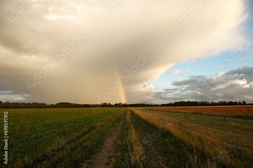 rainbow in the field above the road