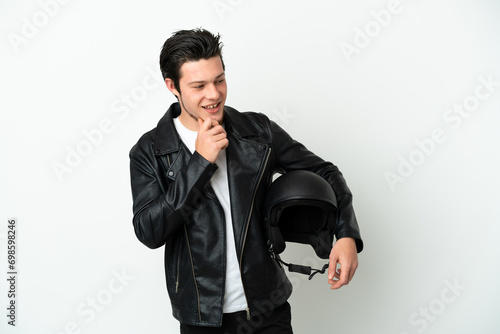 Russian man with a motorcycle helmet isolated on white background looking to the side and smiling