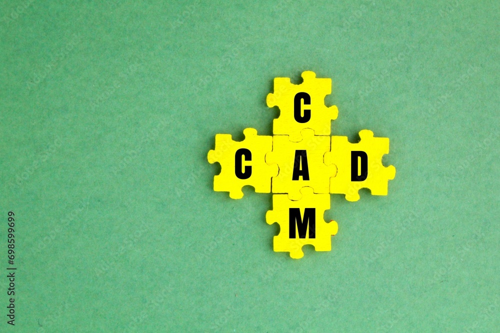 Fototapeta premium yellow puzzle with the letters CAD CAM or the words Computer Aided Design and Computer Aided Manufacturing