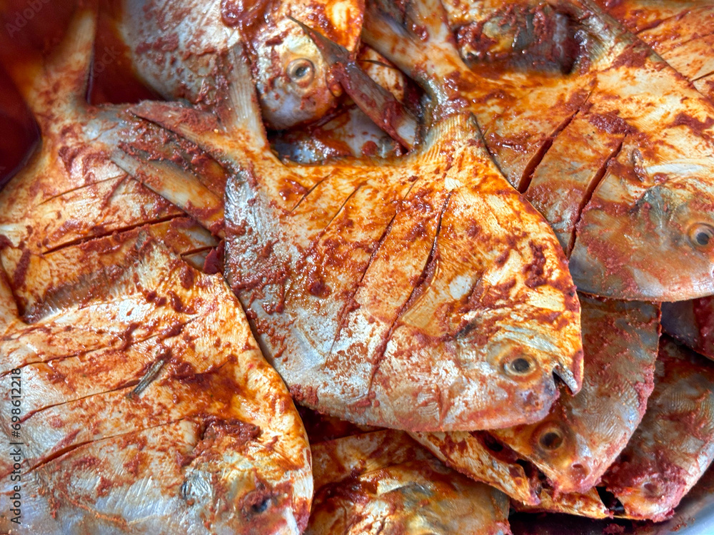 Raw Pomfret fish or butter fish or Poplet fish uncooked and ready to fry closeup