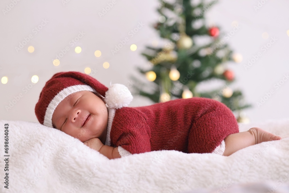 child in santa claus clothes sleeping on fluffy bed. child in santa claus clothes sleeping on fluffy bed.