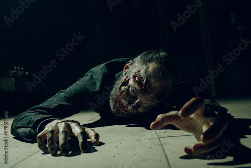 Obraz na plátně Zombie male creeps on floor halloween concept