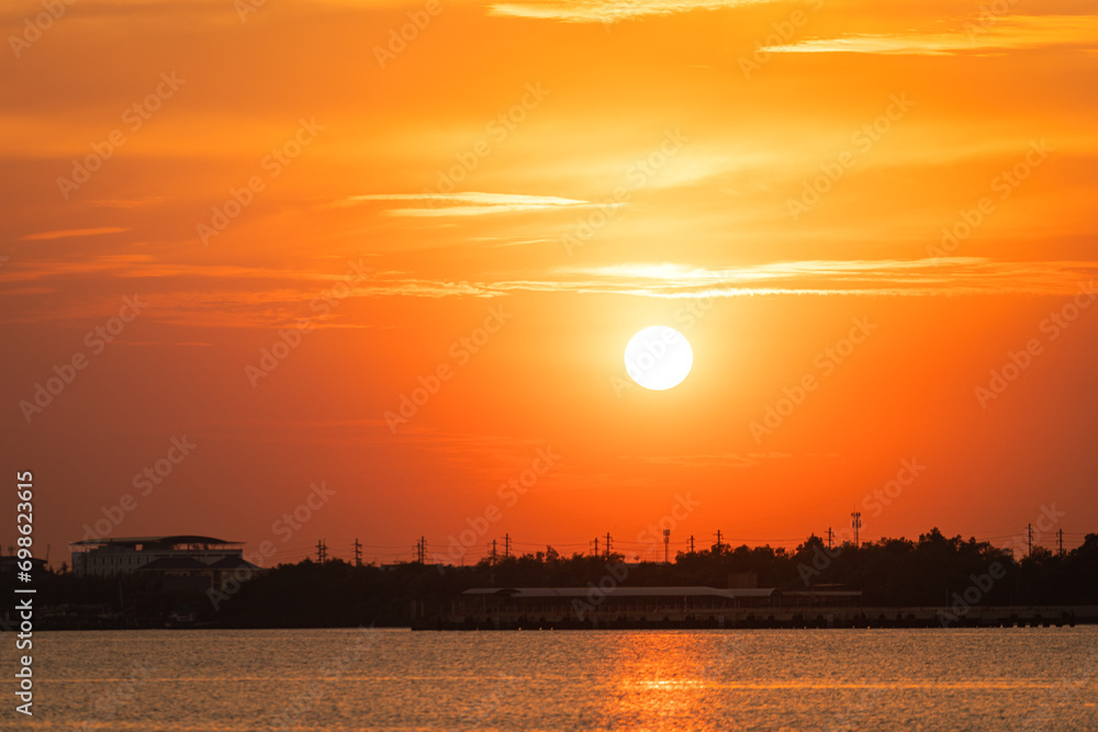 Beautiful view of the orange sunlight during sunset time in the golden hour with river on foreground. Nature view scene. Beautiful view of the orange sunlight during sunset time in the golden hour with river on foreground. Nature view scene.