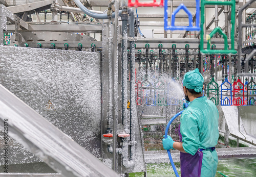 Worker disinfecting interior of a butchery.