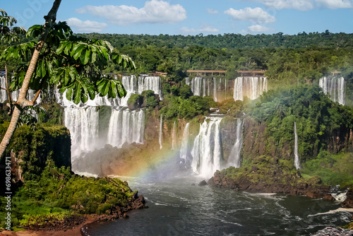 Water cascading over the Iguacu falls with rainbow in Brazil photo