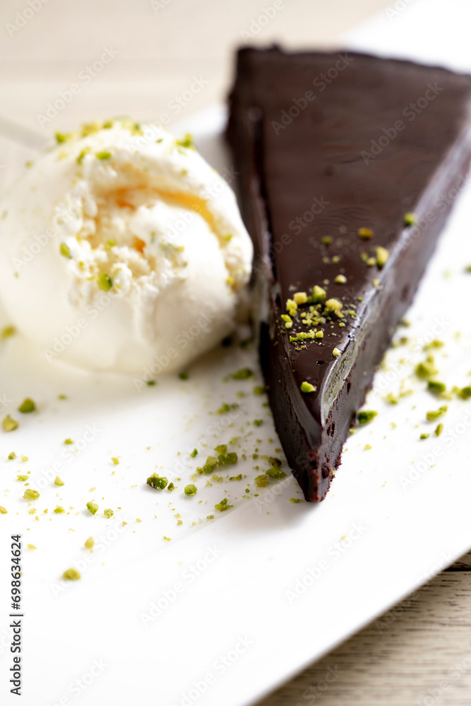 Chocolate cake brownie with ice cream and pistachio on white background Chocolate cake brownie with ice cream and pistachio on white background