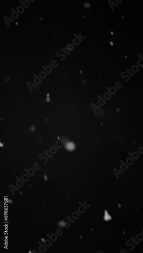 snowfall overlay, black background - winter, slowly falling snow effect, slow motion, vertical video