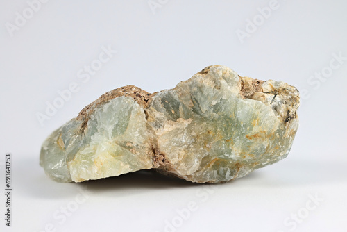Prehnite is a greenish and hard silicate mineral that is popular as cabochon material photo