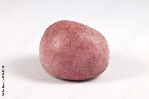 Rhodonite is a manganese, iron, and calcium silicate, and s desirable gem and ornamental stone photo