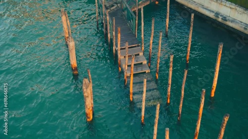 Moving poles in Venice waterways dock and canals with calm waves