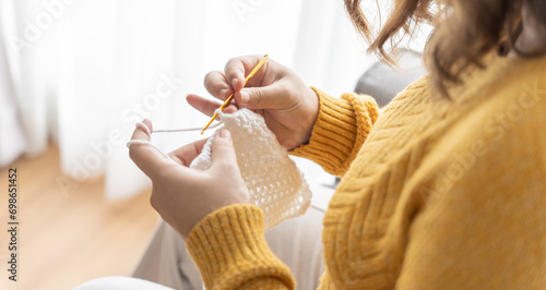 Photos Pregnant asian woman preparing for baby knitting baby winter clothes Pregnancy mother crochet kid cloth at home