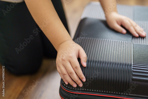 Woman preparing luggage  packing in suitcase  trolley luggage traveling alone solo girl.