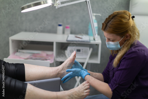 Professional relaxing foot massage performed by a podiatrist. © fotodrobik