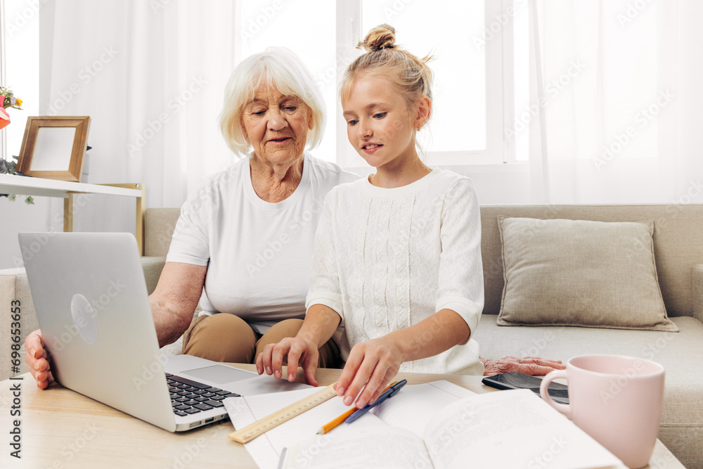 Sofa bonding granddaughter togetherness laptop family hugging education selfie grandmother child smiling Sofa bonding granddaughter togetherness laptop family hugging education selfie grandmother child smiling