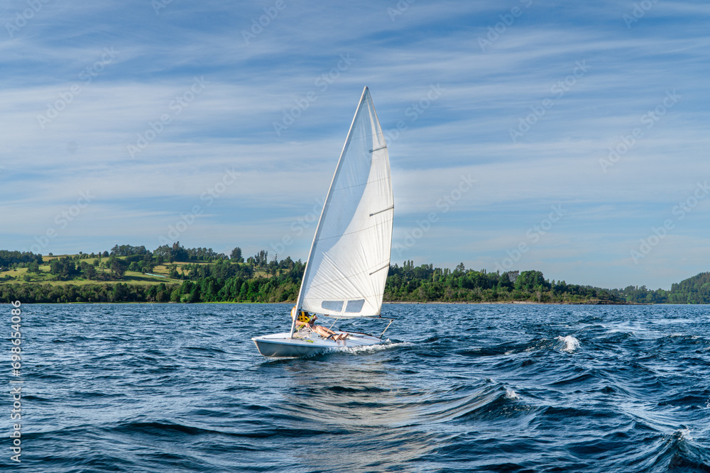 Fototapeta premium small laser sail boat in the lake during a summer day