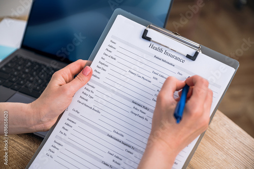 High angle view of doctor signing health insurance medical document in hospital