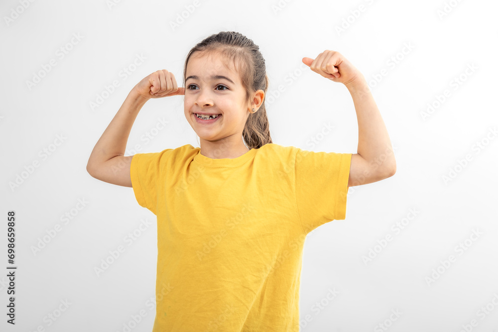 Little girl hand flexing demonstrating biceps isolated on white background. Little girl hand flexing demonstrating biceps isolated on white background.