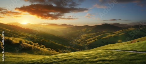 On green hill with beautiful sunset view in summer mountain landscape