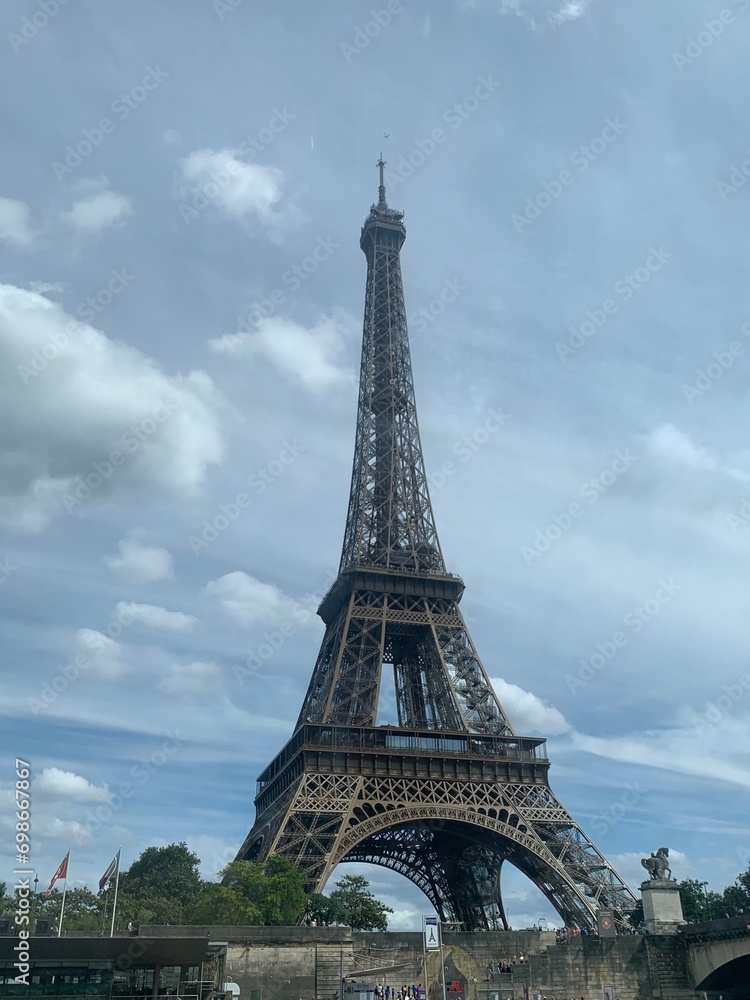 A vertical view from the Sena river of the charming Eiffel Tower along with the skyline of Paris, France, Europe