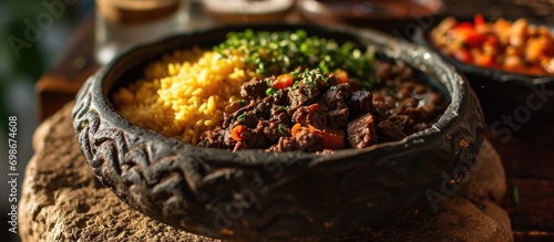 Carne de sol: a traditional dish from the Brazilian northeast made with dried meat, beans, rice, farofa, cassava, and vinaigrette. photo