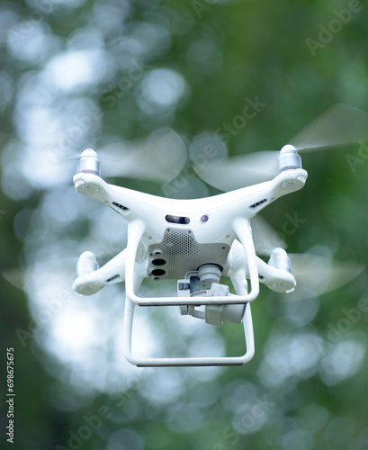 Drone with camera aboard flying in the sky photo