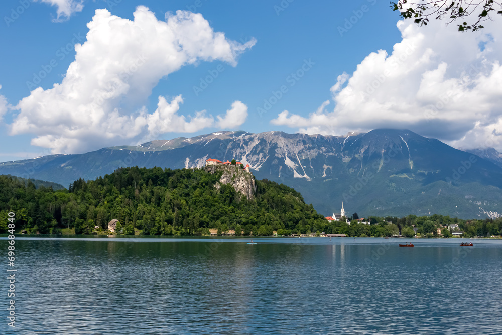 Panoramic view of St. Martina Parish Church and medieval castle at Lake Bled, Upper Carniola, Slovenia. Viewing platform. Serene landscape in remote nature in Julian Alps and Karawanks in summer