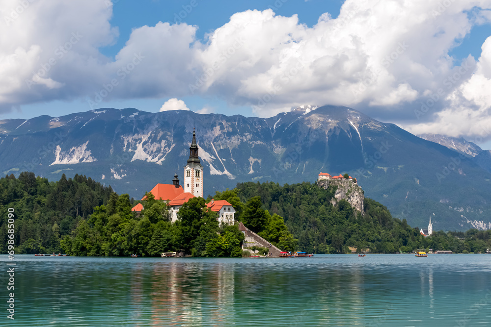 Scenic view of St Mary Church and medieval castle at Lake Bled, Upper Carniola, Slovenia. Viewing platform. Water reflection of serene landscape in remote nature in Julian Alps and Karawanks in summer