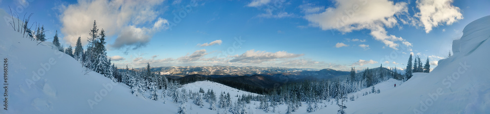 panorama mountain winter landscape. snowy mountains and blue sky with clouds panorama mountain winter landscape. snowy mountains and blue sky with clouds