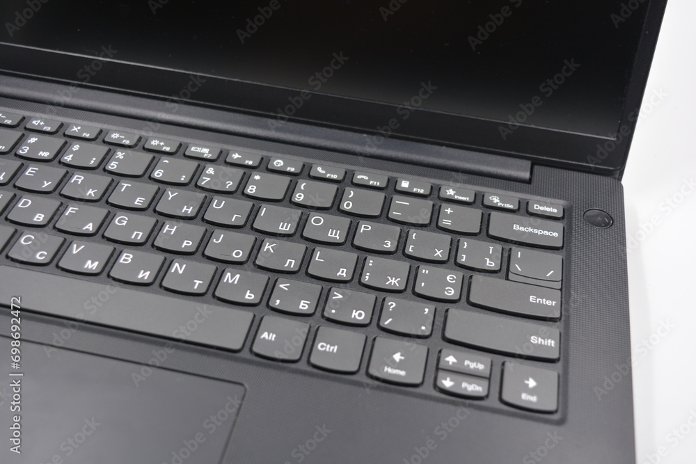 A beautiful stylish black 14 inch laptop with a simplified, miniature, slim keyboard with no calculator keys. A beautiful stylish black 14 inch laptop with a simplified, miniature, slim keyboard with no calculator keys.