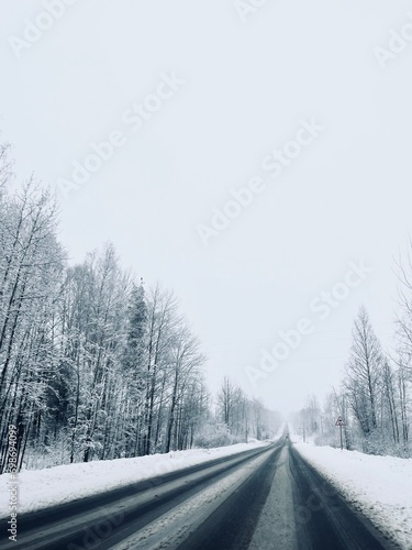 Empty snowy asphalt road, winter © Oksana