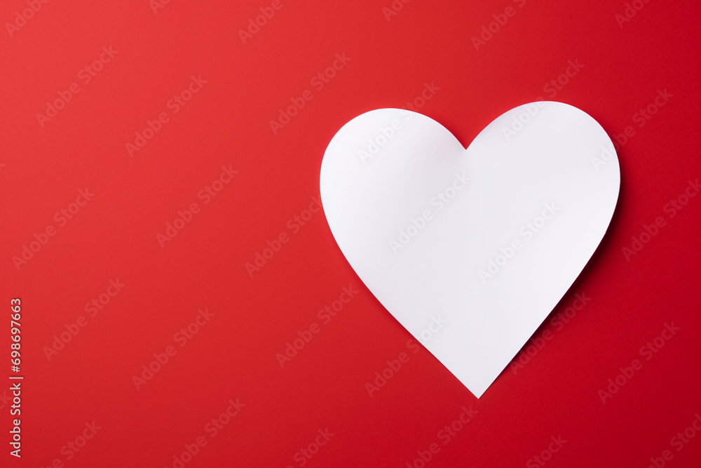 red heart paper and blank with note card on red background