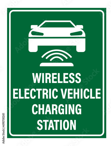 Wireless electric vehicle charging station. Information road sign with silhouette of electric car on permanent magnetic gear wireless charging. Text below.