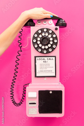 Crop Hand of unrecognizable female on Retro Pink and black Phone