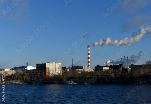 The smoking pipe of a thermal power plant and a reservoir. The urban landscape in Yekaterinburg.