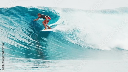 Surfer rides the wave in the ocean. Sultans surf break near the island on Huraa in the Maldives photo