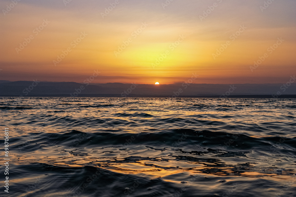 A nice view of a sunset over a pool of water