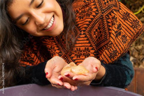 Woman demonstrating the caring for a Mexican Ajolote
