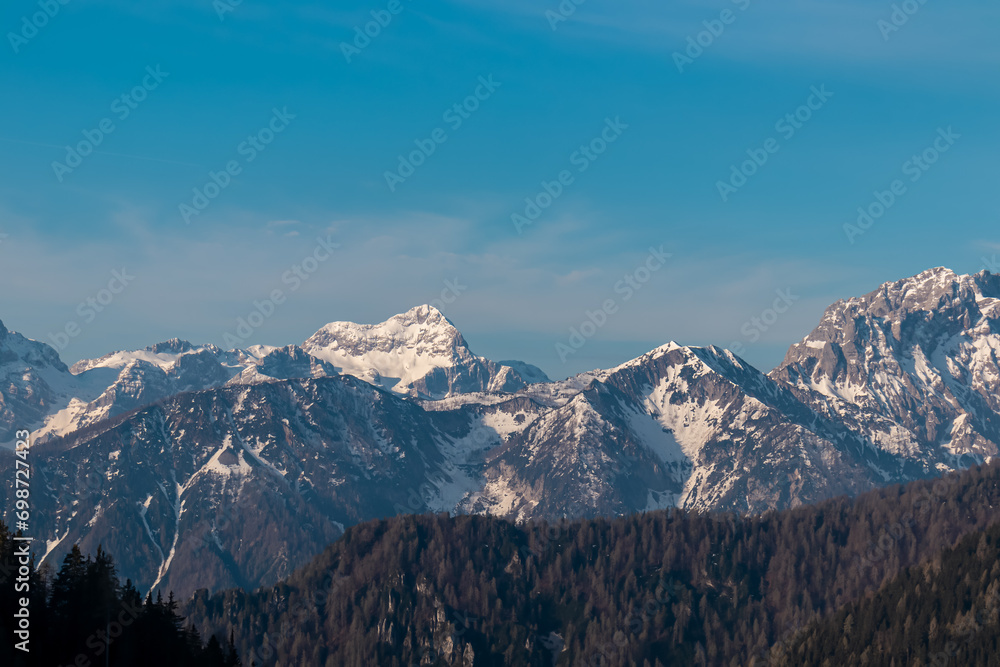 Panoramic view of snow covered mountain range Julian Alps seen from the Karawanks in Carinthia, Austria. Looking at mountain peak Triglav. Tranquil scene in alpine landscape in Slovenian Austrian Alps