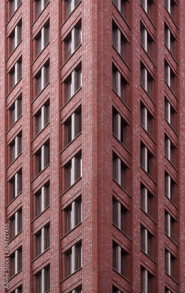 Patterned facade of a red brick high-rise building in the business district of Amsterdam Patterned facade of a red brick high-rise building in the business district of Amsterdam