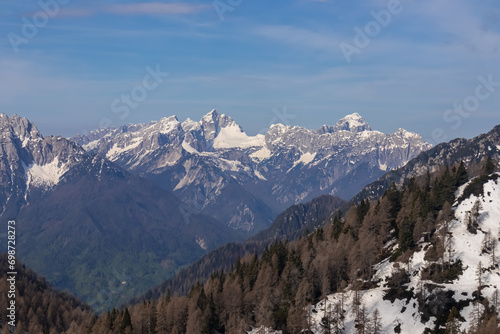 Panoramic view of snow covered mountain range Julian Alps seen from the Karawanks in Carinthia, Austria. Looking at mountain peak Triglav. Tranquil scene in alpine landscape in Slovenian Austrian Alps © Chris