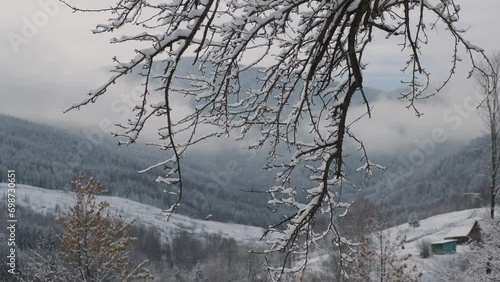 Beautiful winter in a mountain village. A view of the houses among the mountains in winter photo