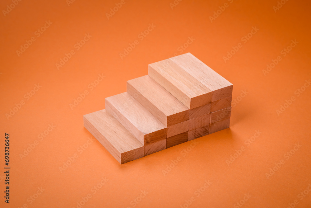 Wooden steps made of blocks as an idea of investment and profit growth in achieving a goal Wooden steps made of blocks as an idea of investment and profit growth in achieving a goal