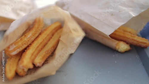 Close-up of fried churros being served in a fast food cafe. 