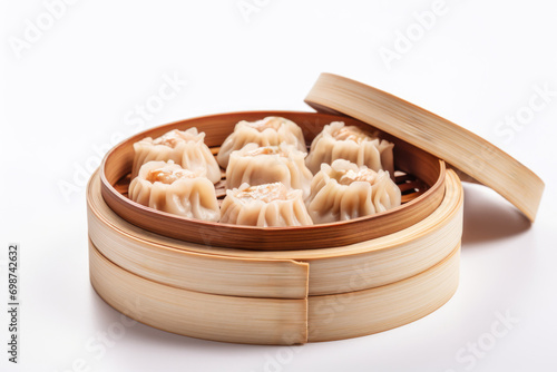 Bamboo steamer filled with Chinese Shumai dumplings on white background.For restaurant menus,culinary blogs and websites. photo