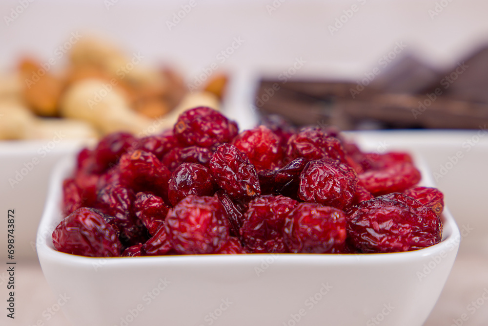 Close-up of dried cranberries in a bowl. Selective focus. Close-up of dried cranberries in a bowl. Selective focus.