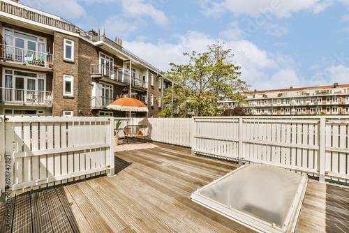 Terrace deck with hot tub and white fence photo