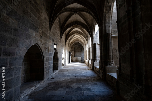 Interior corridor in ancient landmark building with gothic arch in a medieval architecture in Narbonne, France